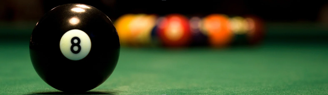 8 Ball with pool balls in the background