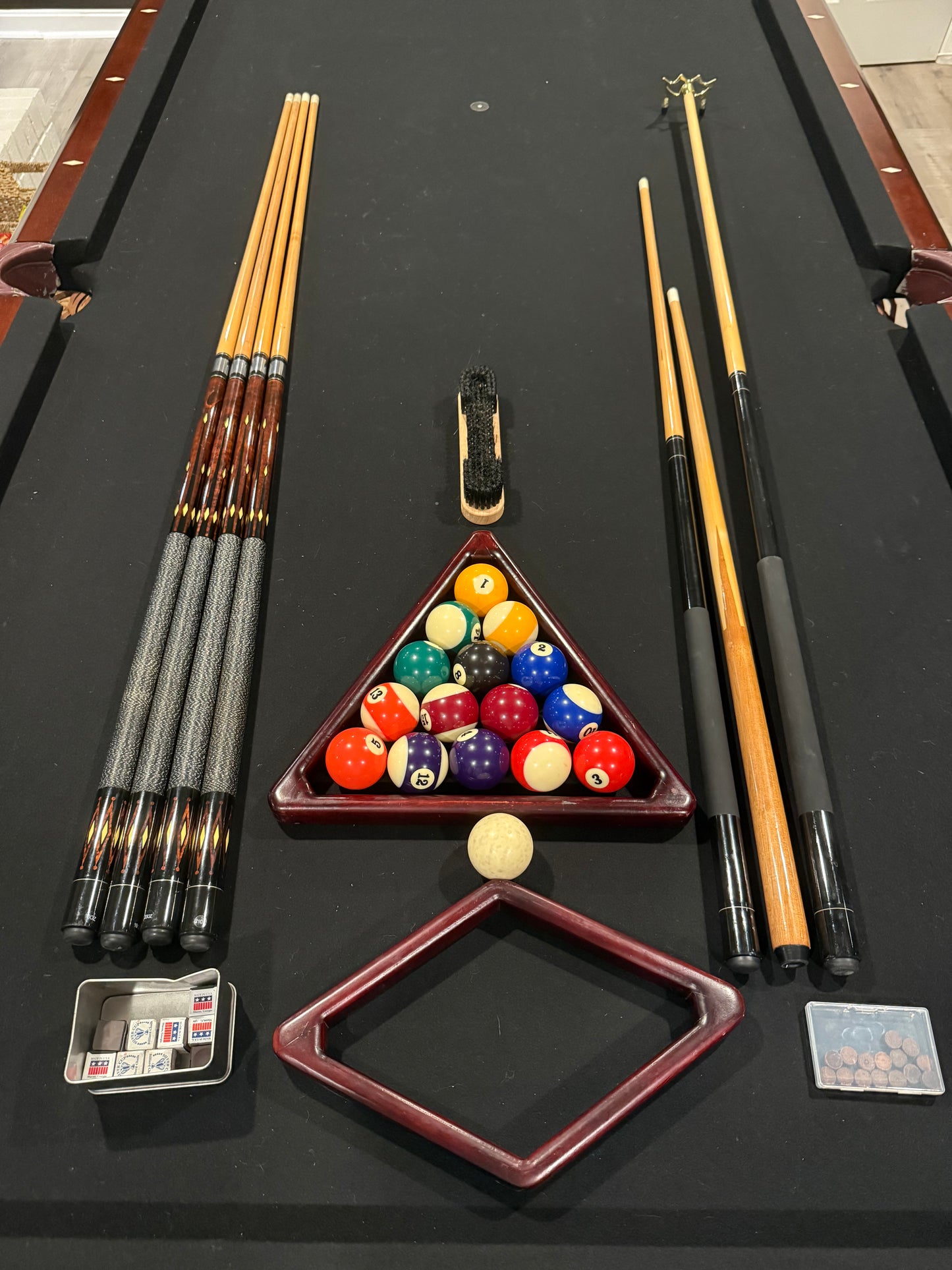 Top of pool table, cues and pool balls
