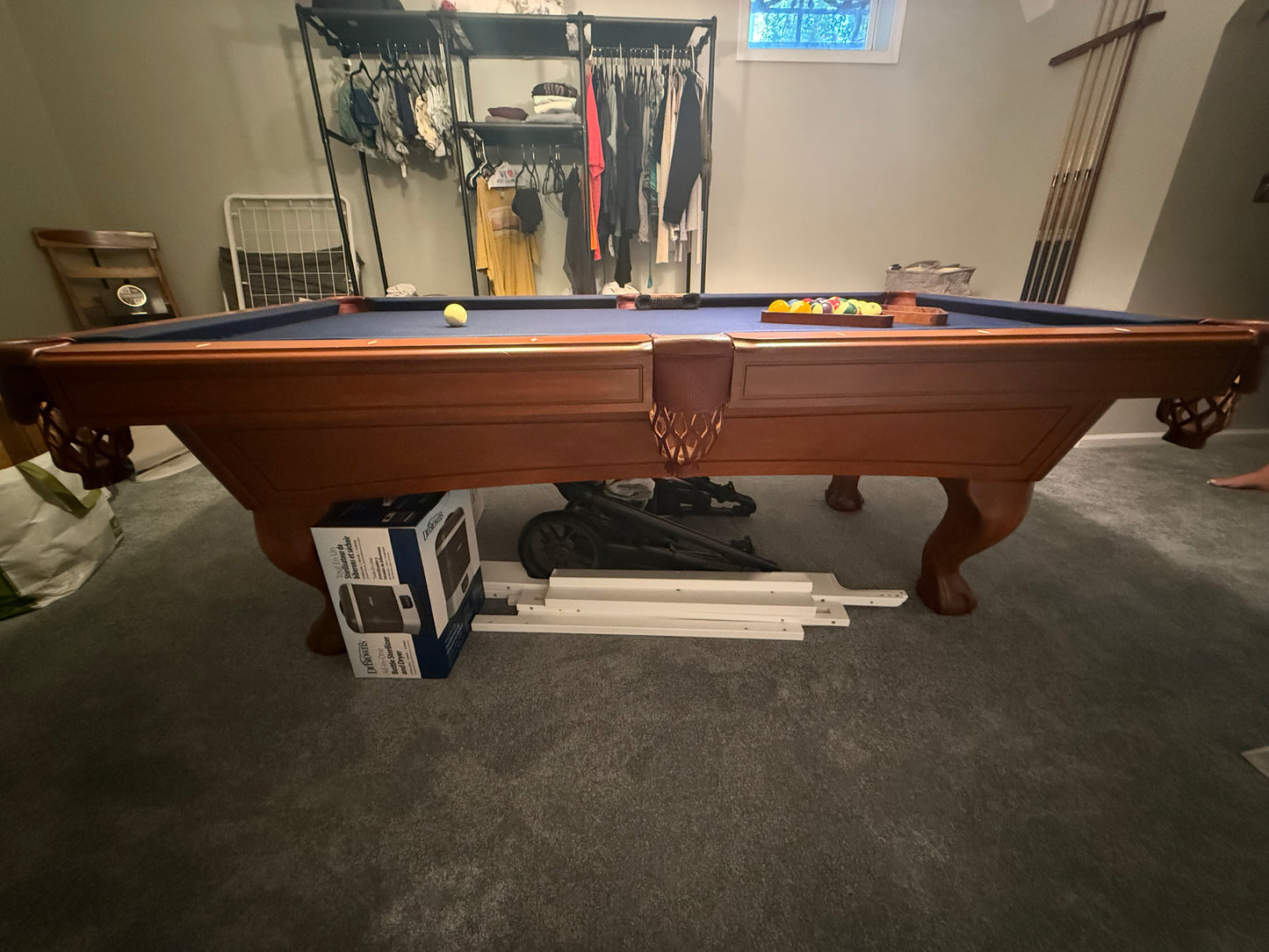 Pool table with pool cues and balls in a room