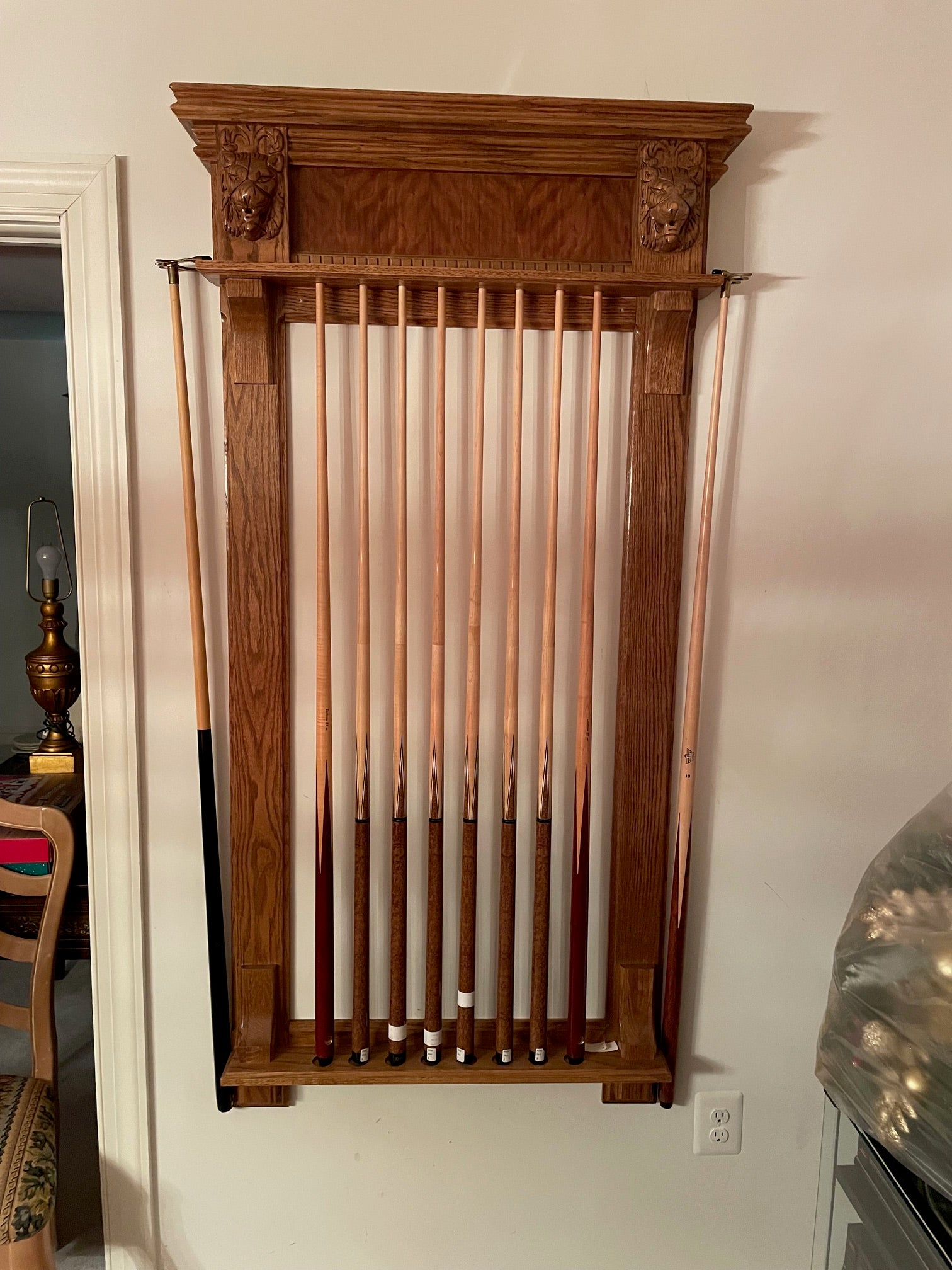Wooden pool cue rack with multiple cues
