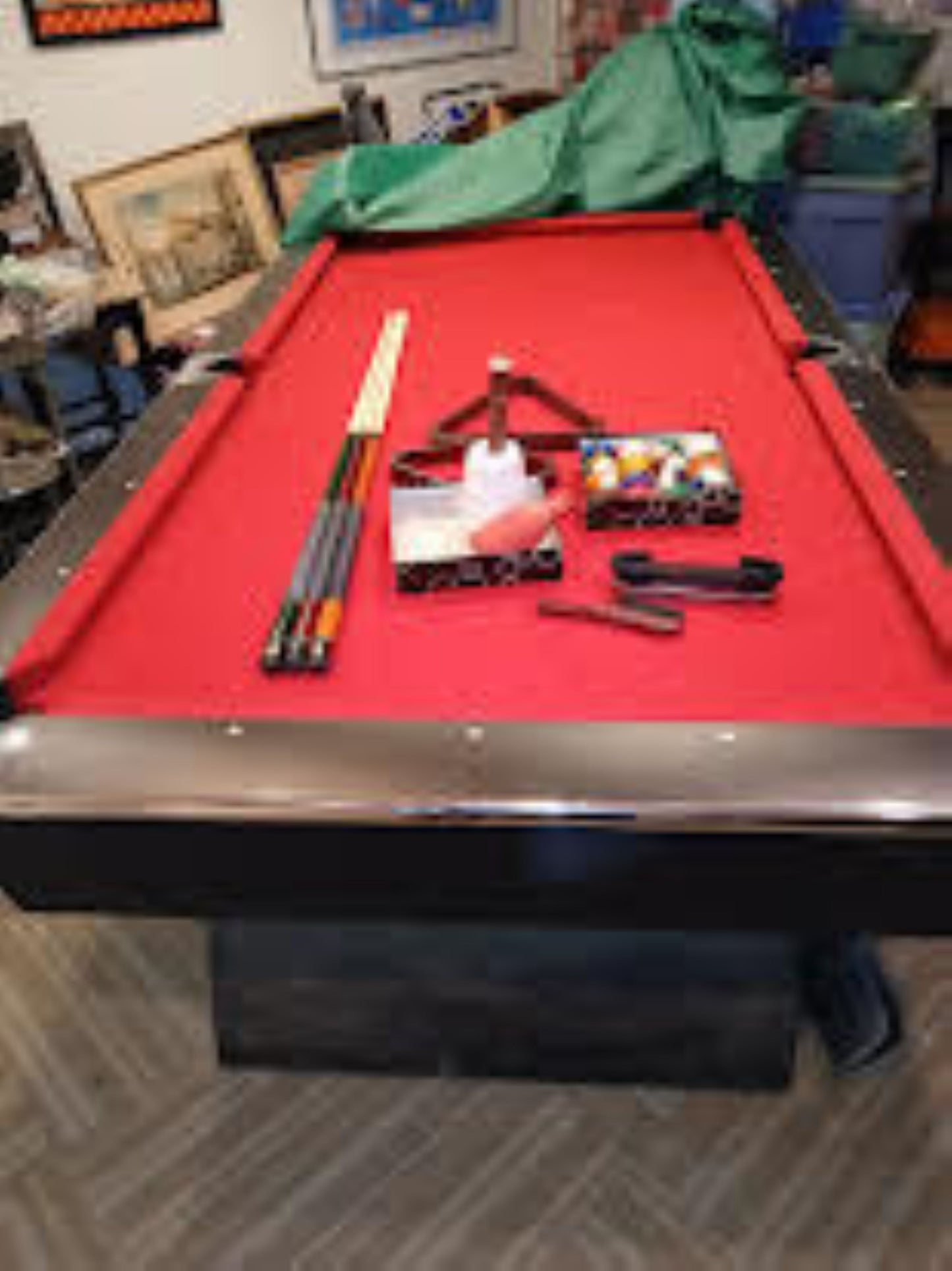 pool table with red felt and accessories on top