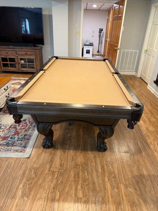 Pool table in a room with wooden flooring 