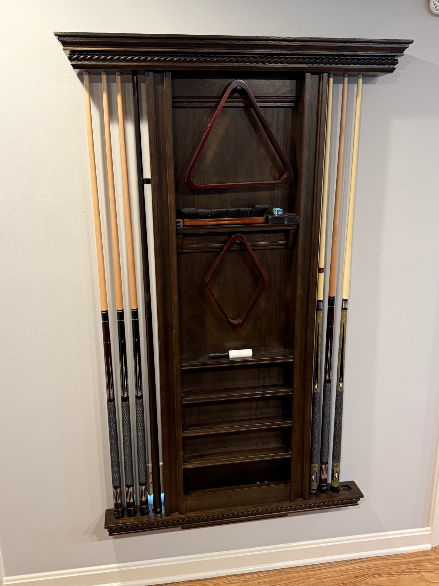 Set of pool cues in a wooden rack